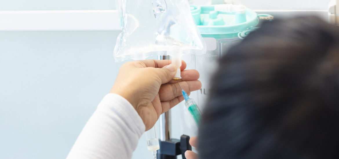 Biracial female doctor preparing drip in sunny hospital room. Medicine, healthcare and medical services, unaltered.