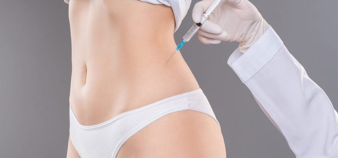 Beauty injection for slimming. Young woman getting lipolysis treatment at plastic surgery clinic, closeup